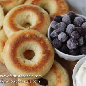 These Low Carb, Keto Bagels are based on the Fathead dough recipe and use mozzarella cheese, cream cheese, almond flour and eggs to make a dough that's surprisingly light and cream-cheese-spreadable. Add some smoked salmon, capers and sliced red onion for a Bagel and Lox. #farmsteadchic #lowcarbbagel #ketobagel #bagelandlox #smokedsalmonbagel #fatheadbagel #lowcarbbreakfast #ketobreakfast